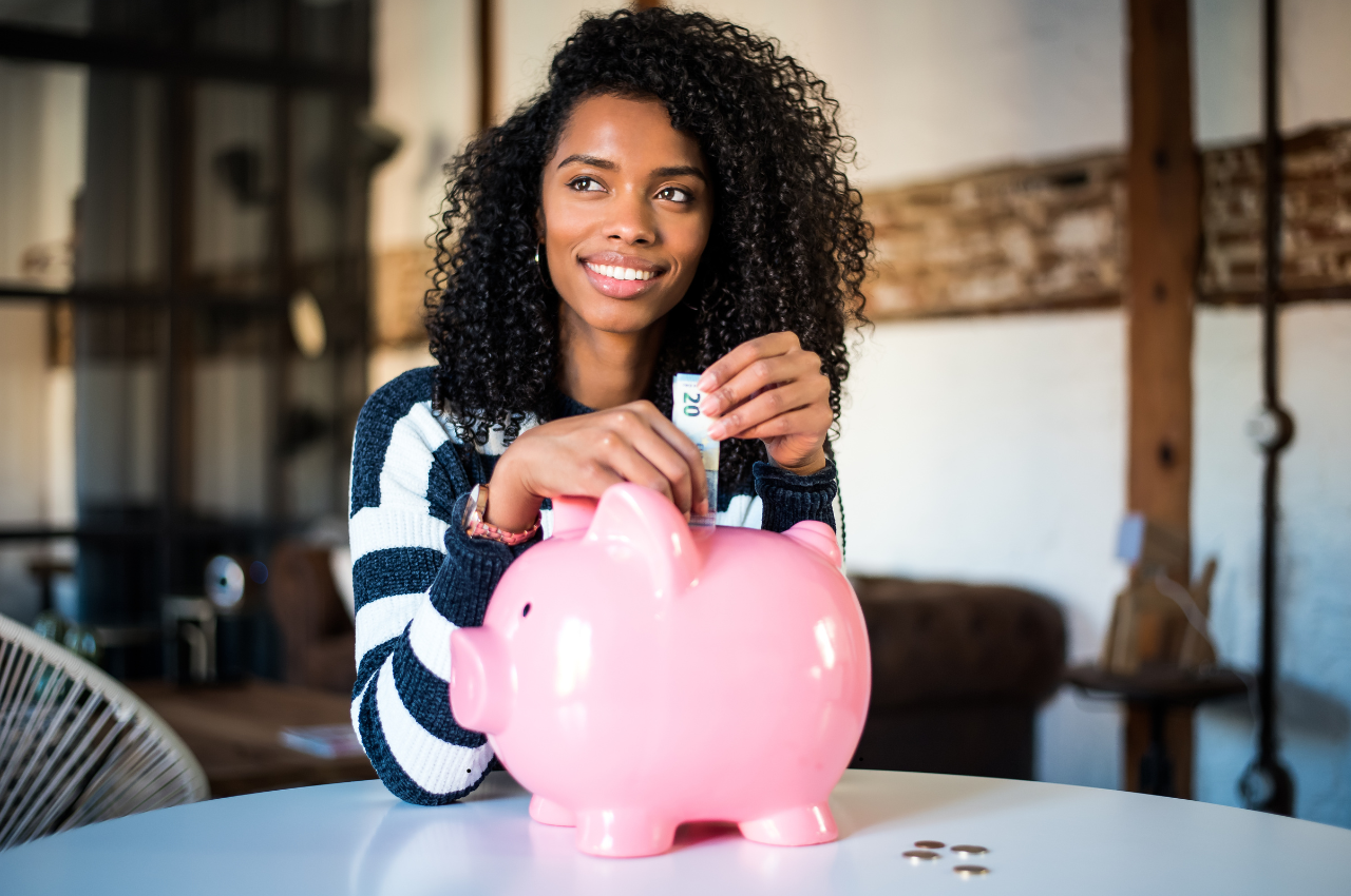 girl with pink piggy bank